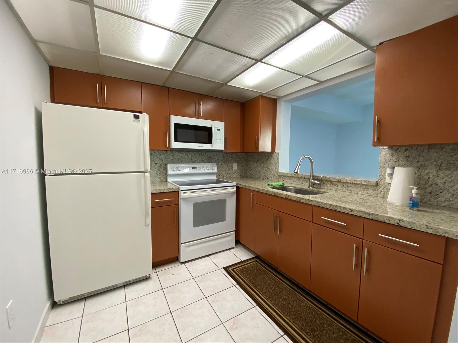 a kitchen with sink cabinets and stainless steel appliances