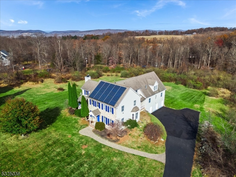 an aerial view of a house with big yard