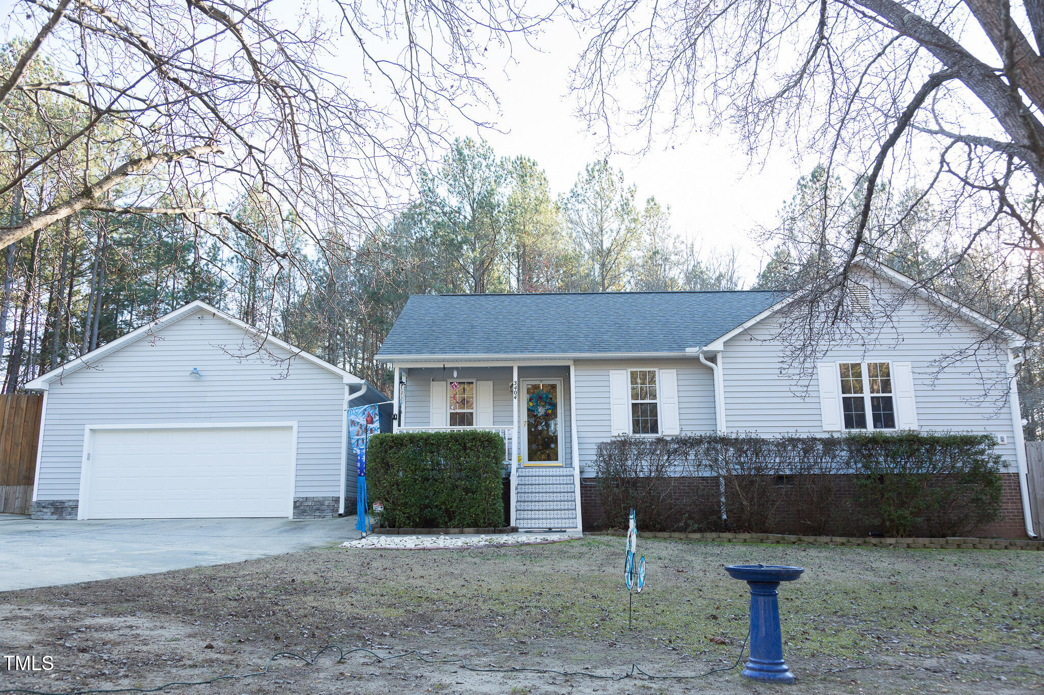 a view of a house with a yard and large tree