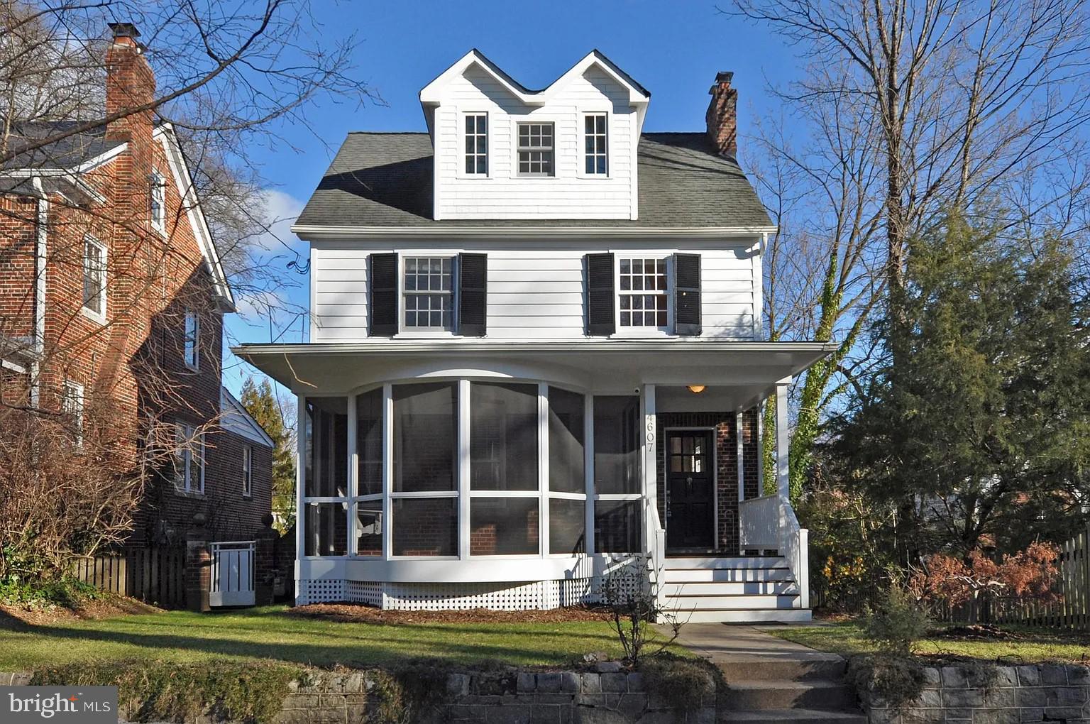 front view of a house with a yard and potted plants