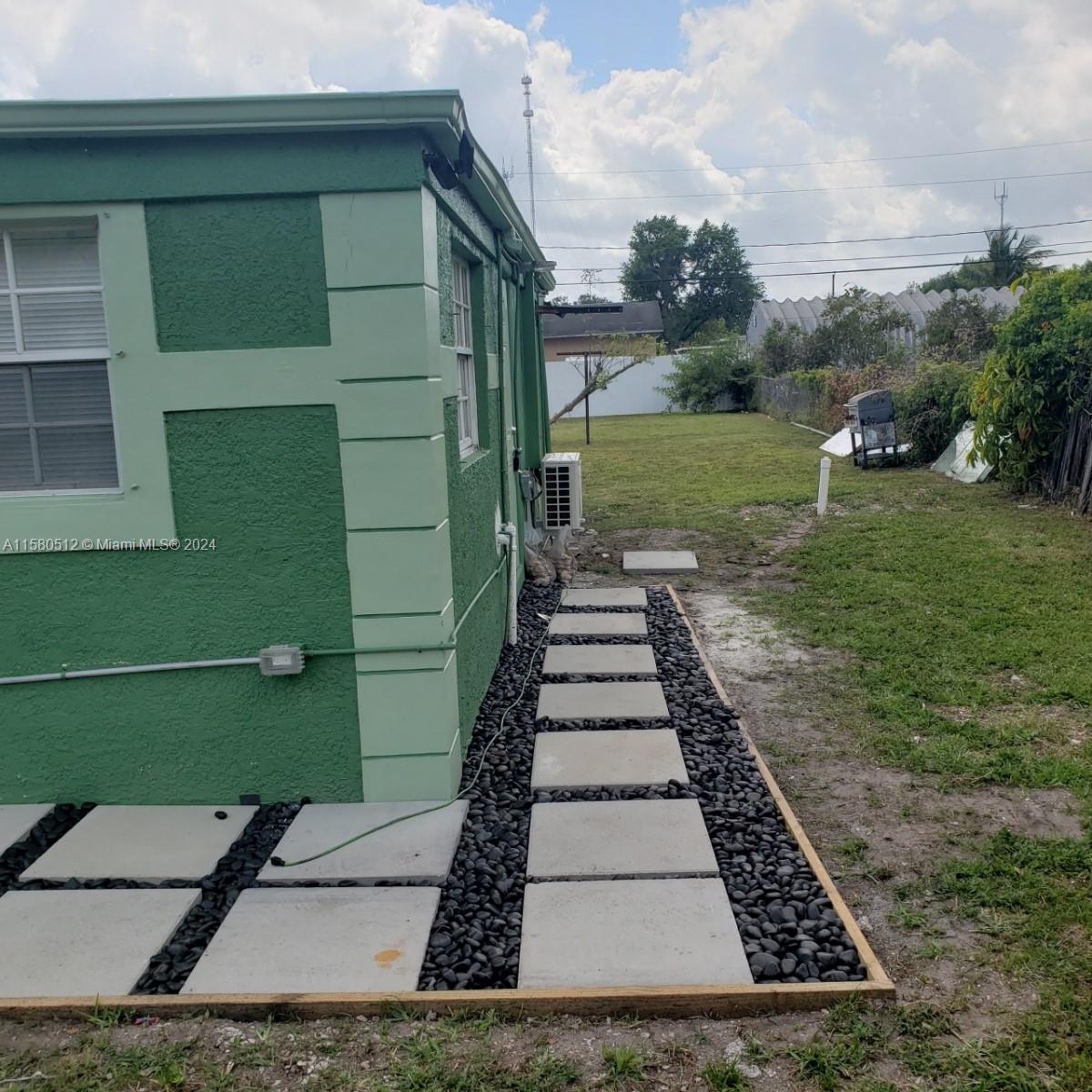 a view of a backyard with pathway