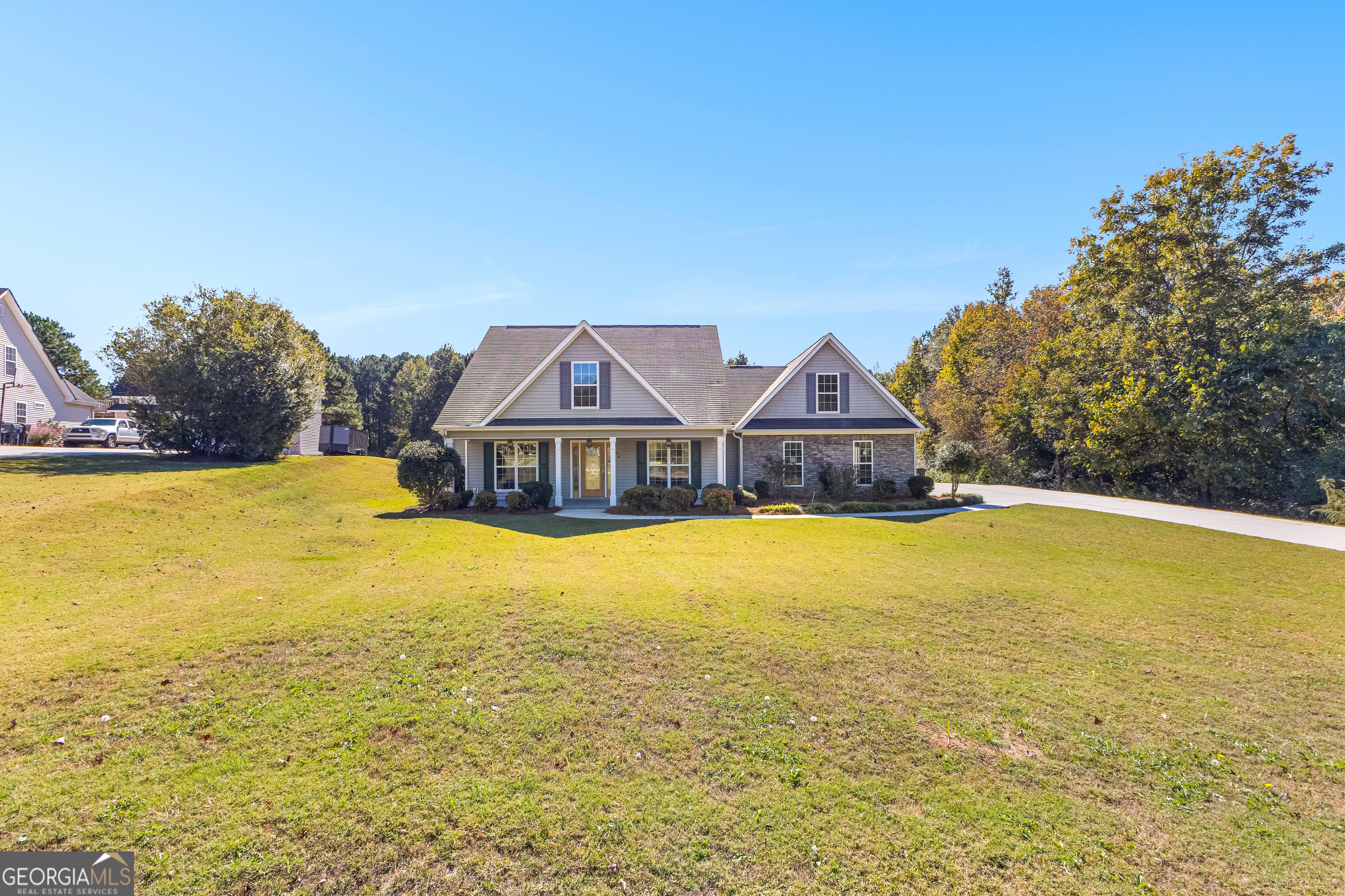 a front view of a house with a big yard