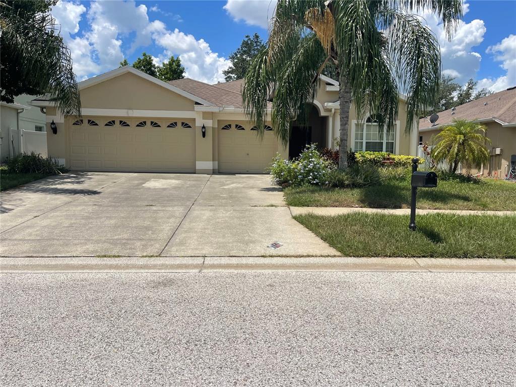 a front view of a house with a yard and garage