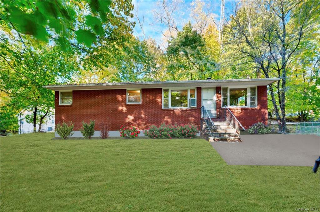 Single story home featuring a front lawn