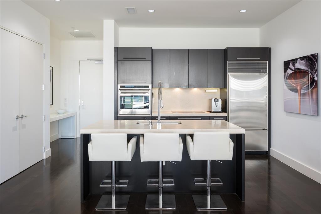 a kitchen with a table chairs refrigerator and microwave