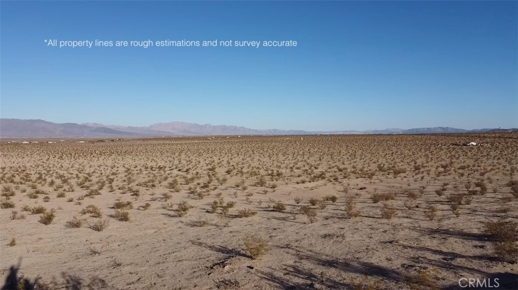 a view of a field with an ocean