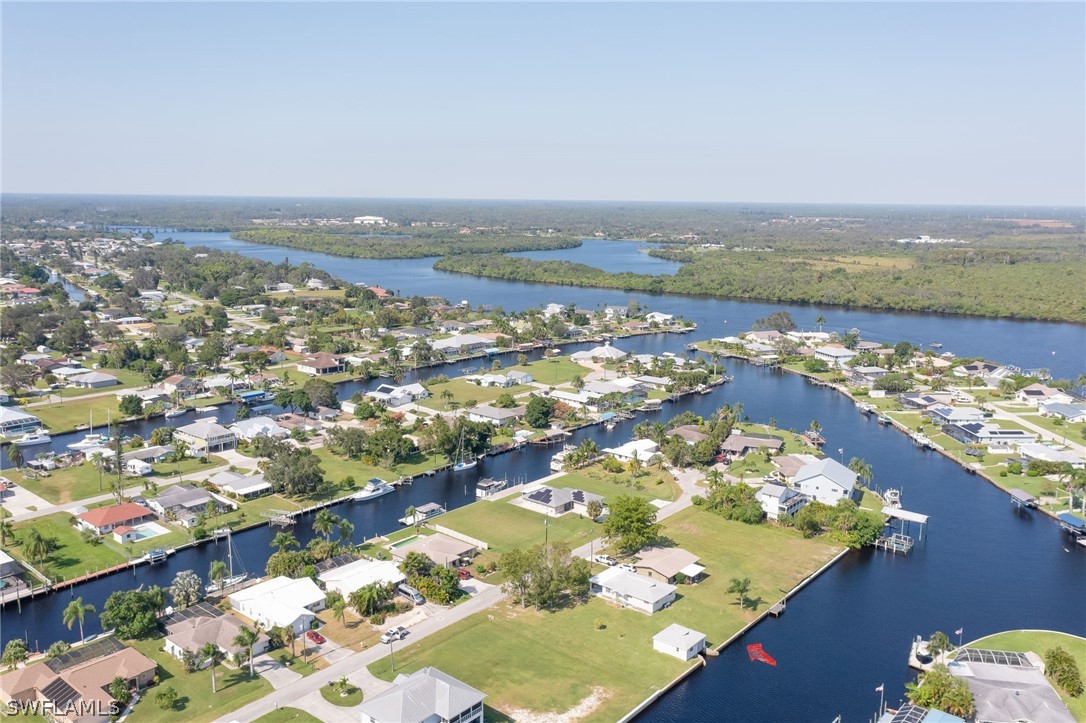 an aerial view of ocean and residential houses