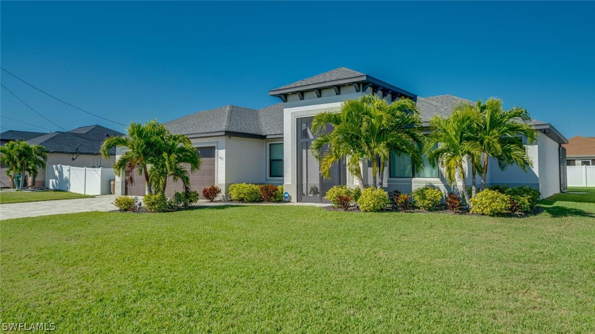 a view of a house with a yard and plants