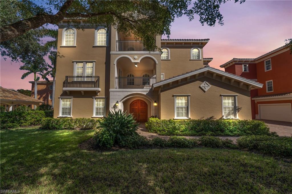 Mediterranean / spanish-style home featuring a garage, a yard, and a balcony