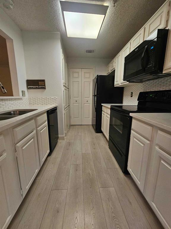 a kitchen with a sink stove and microwave