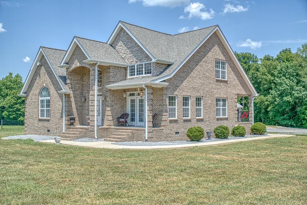 a front view of a house with garden