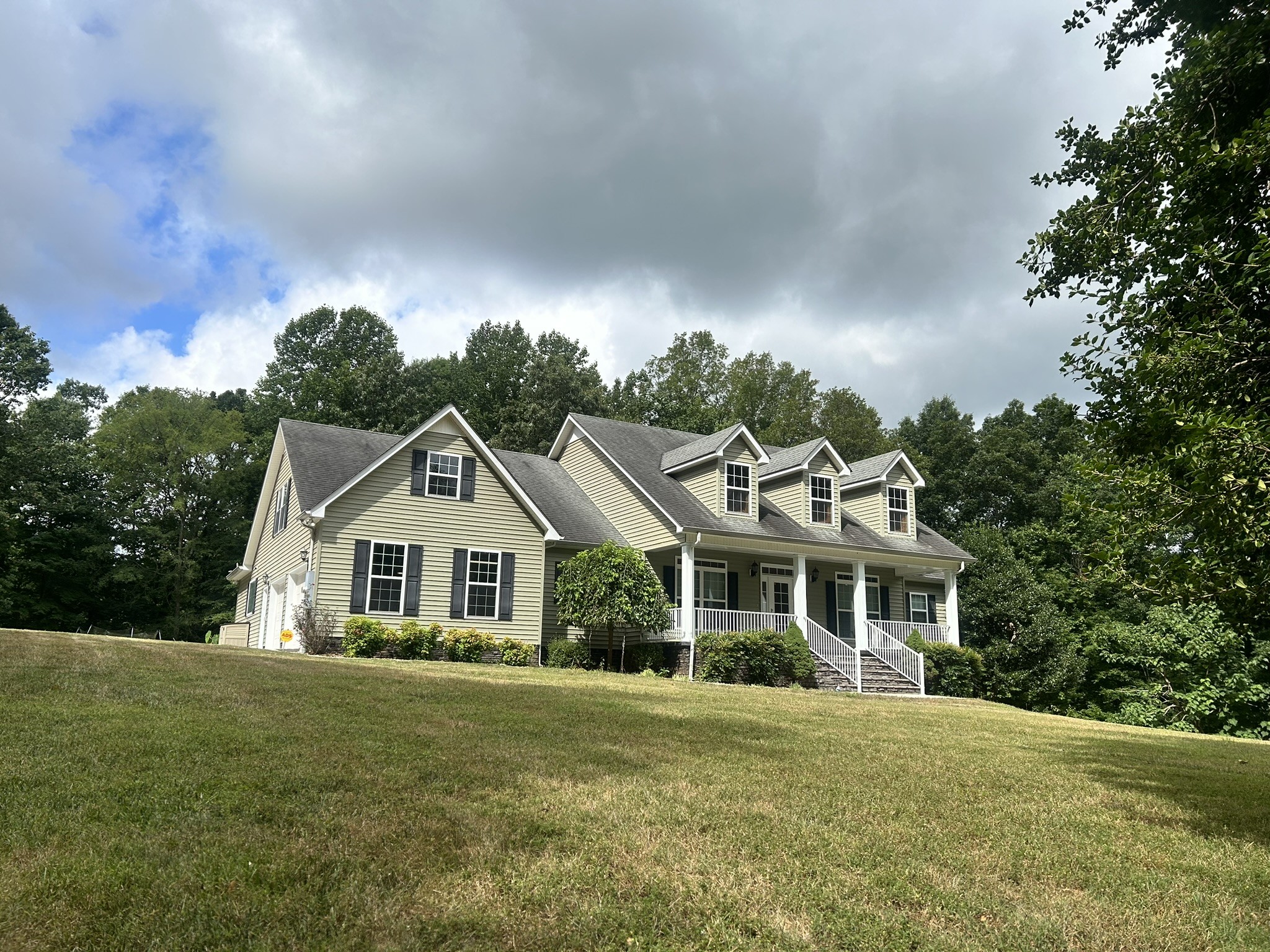 a front view of a house with a garden