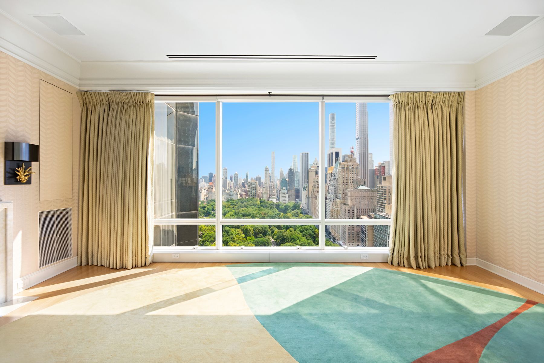 a view of a room with a large window and front door