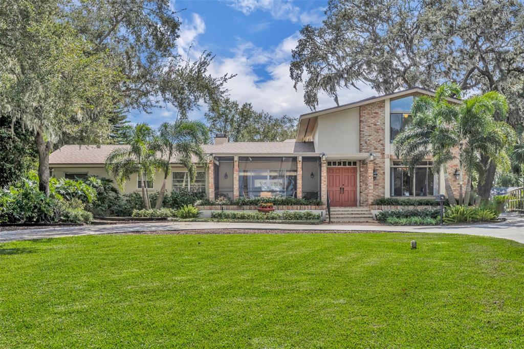 a front view of house with yard outdoor seating and garage