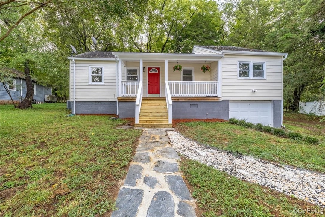 View of front facade with a front lawn, a garage,