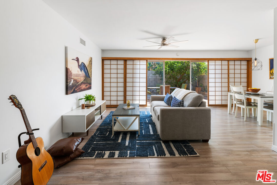 a living room with furniture and a floor to ceiling window