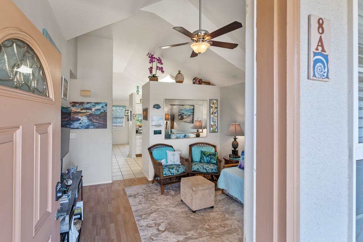 a view of living room filled with furniture and a chandelier