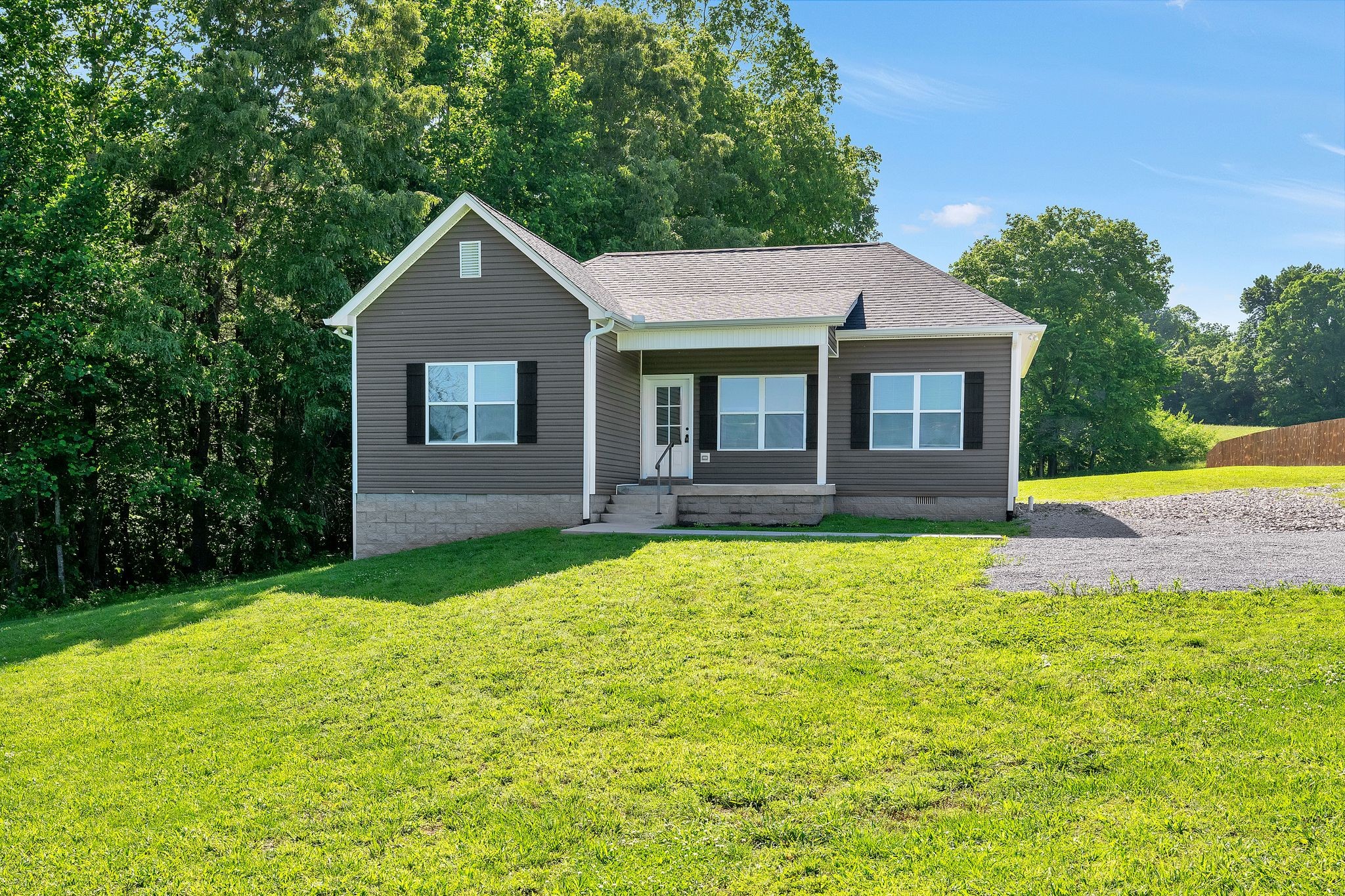 a front view of house with yard and green space