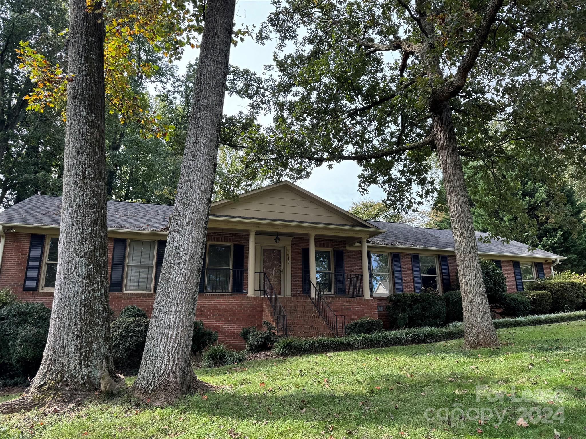 a front view of a house with a yard and porch