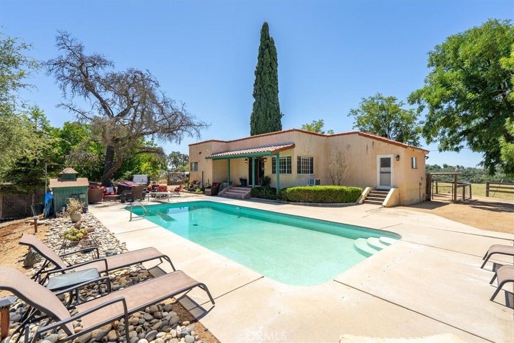 a view of a house with pool porch and sitting area