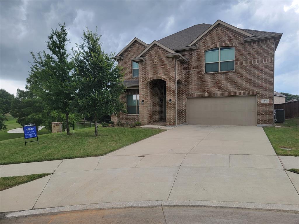 a front view of a house with a yard and a garage