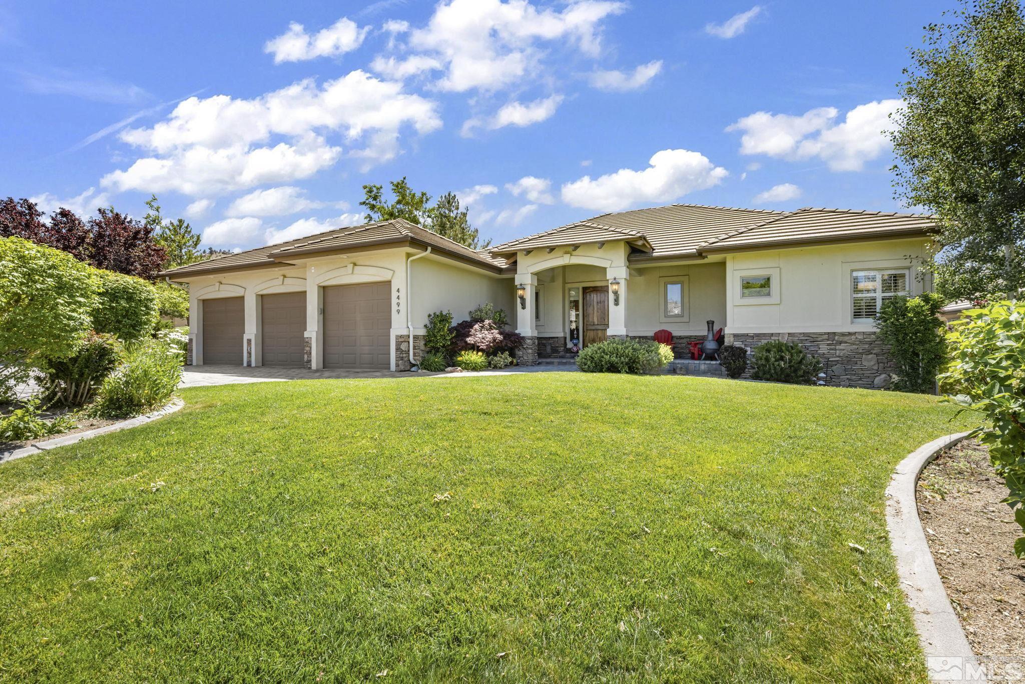 a front view of house with yard and green space