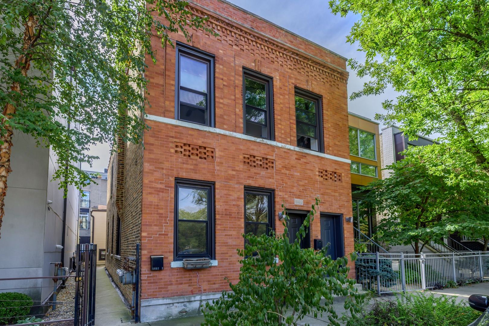 front view of a brick house with a large windows