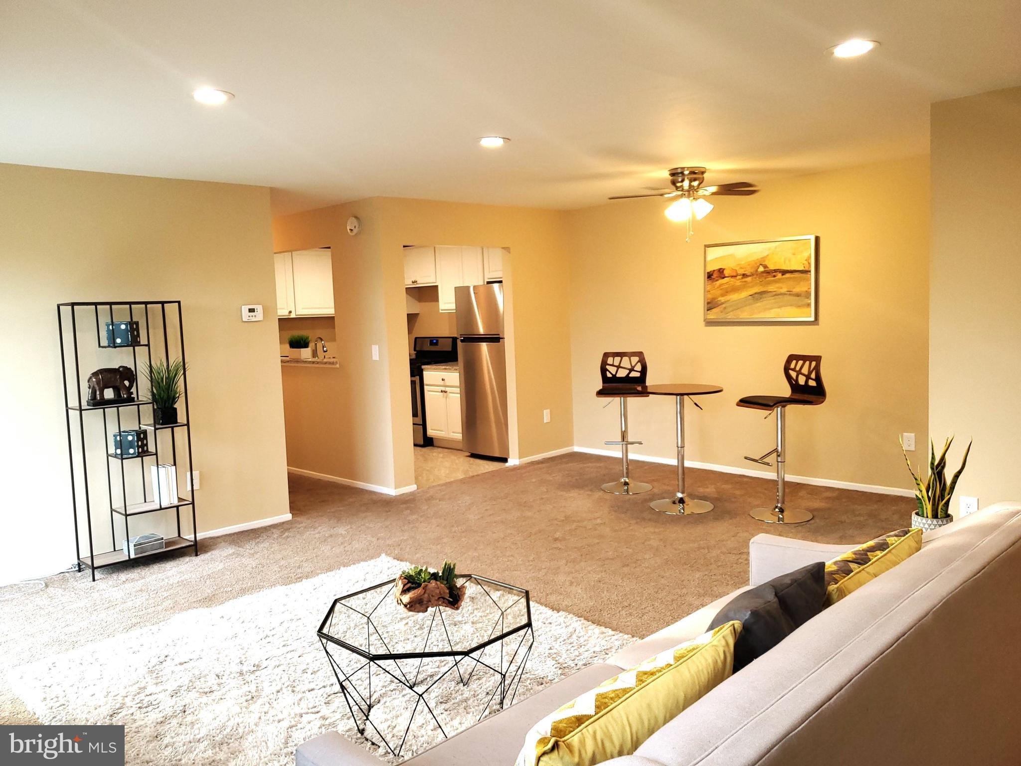 a living room with hard wood flooring and furniture