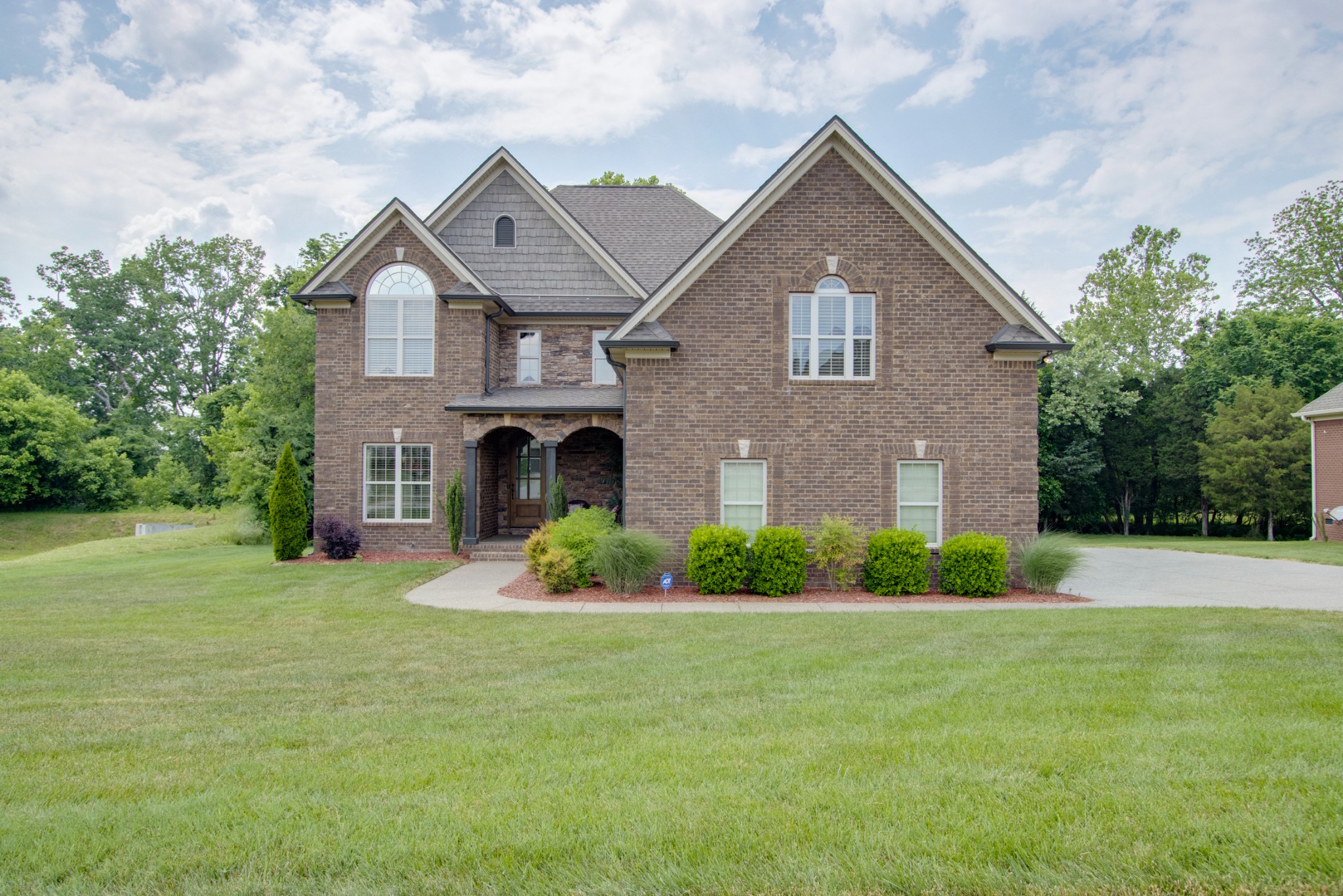 a front view of a house with garden