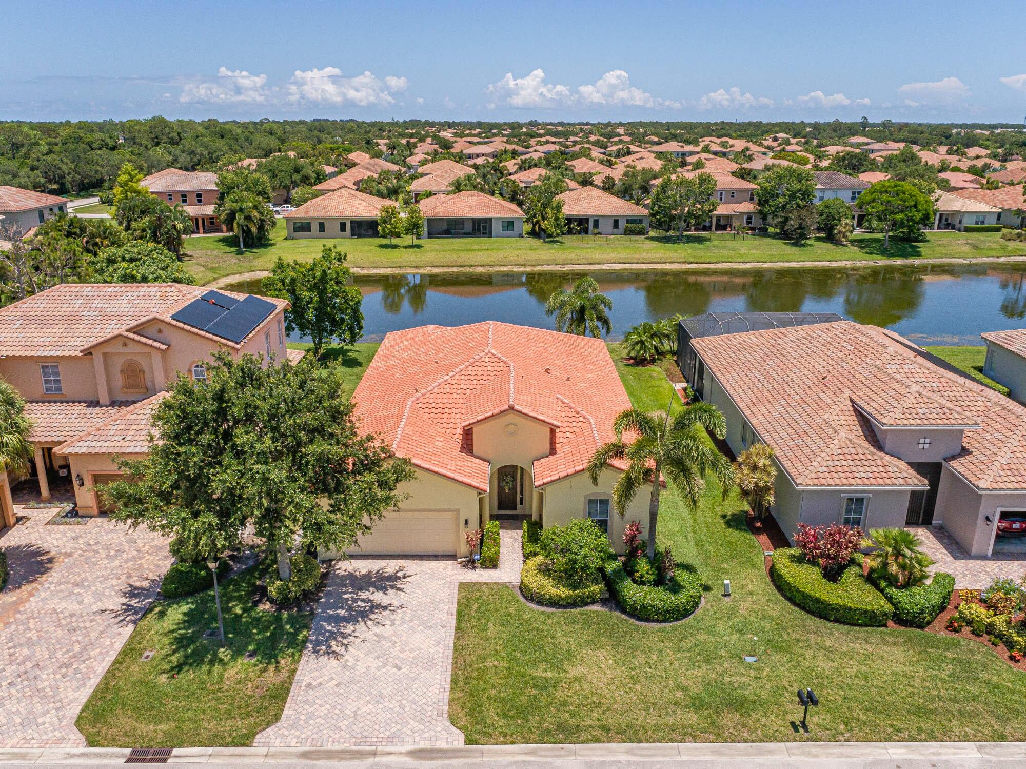 an aerial view of a house with garden space and lake view