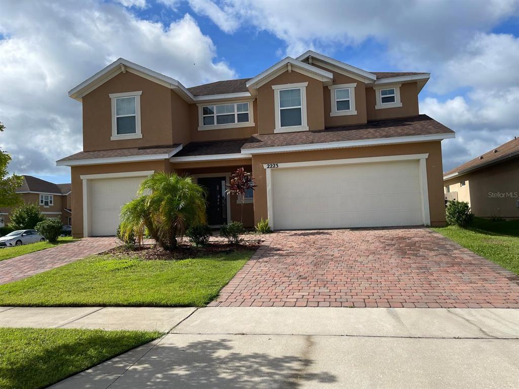 a front view of a house with a yard and garage