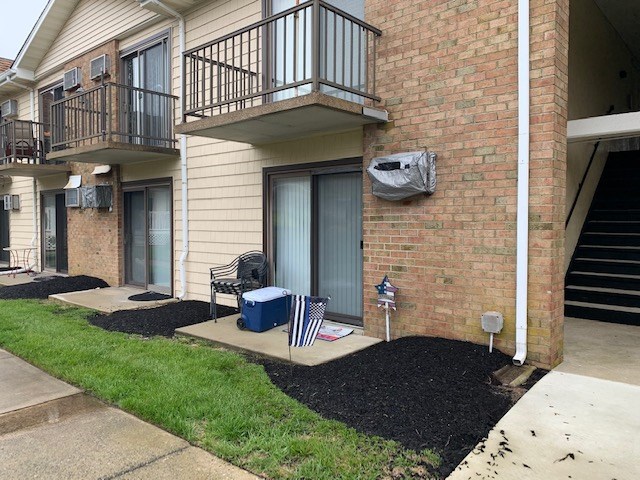 a view of a house with brick walls and a fire pit