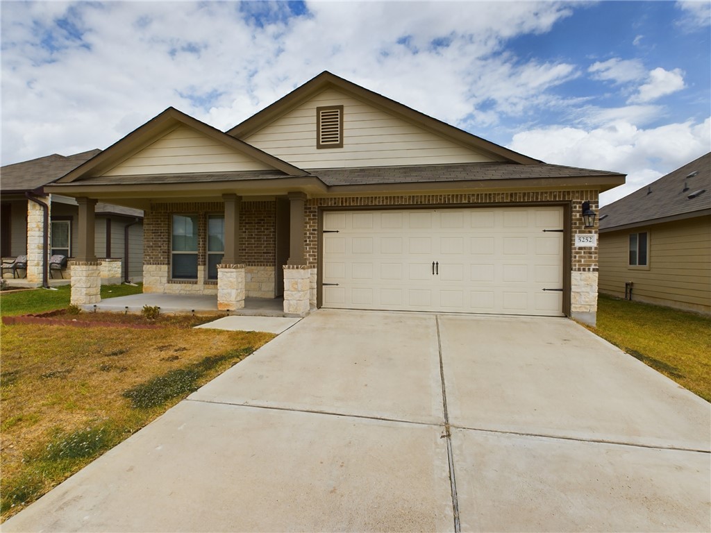 View of front of property with a garage and a fron