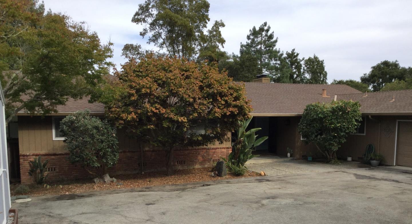 a view of a barn house and a tree in front of it