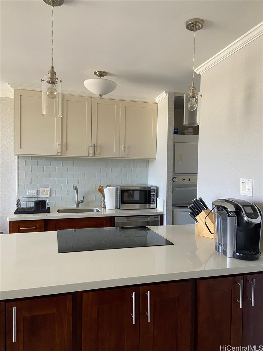 a kitchen with stainless steel appliances a sink a stove and refrigerator