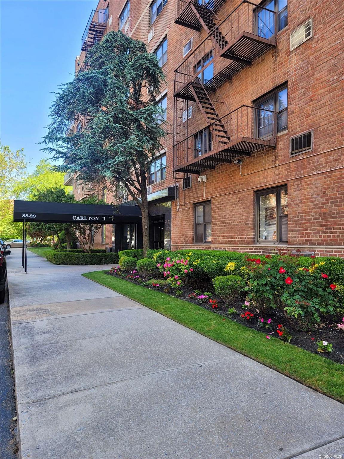 a view of a brick building next to a yard