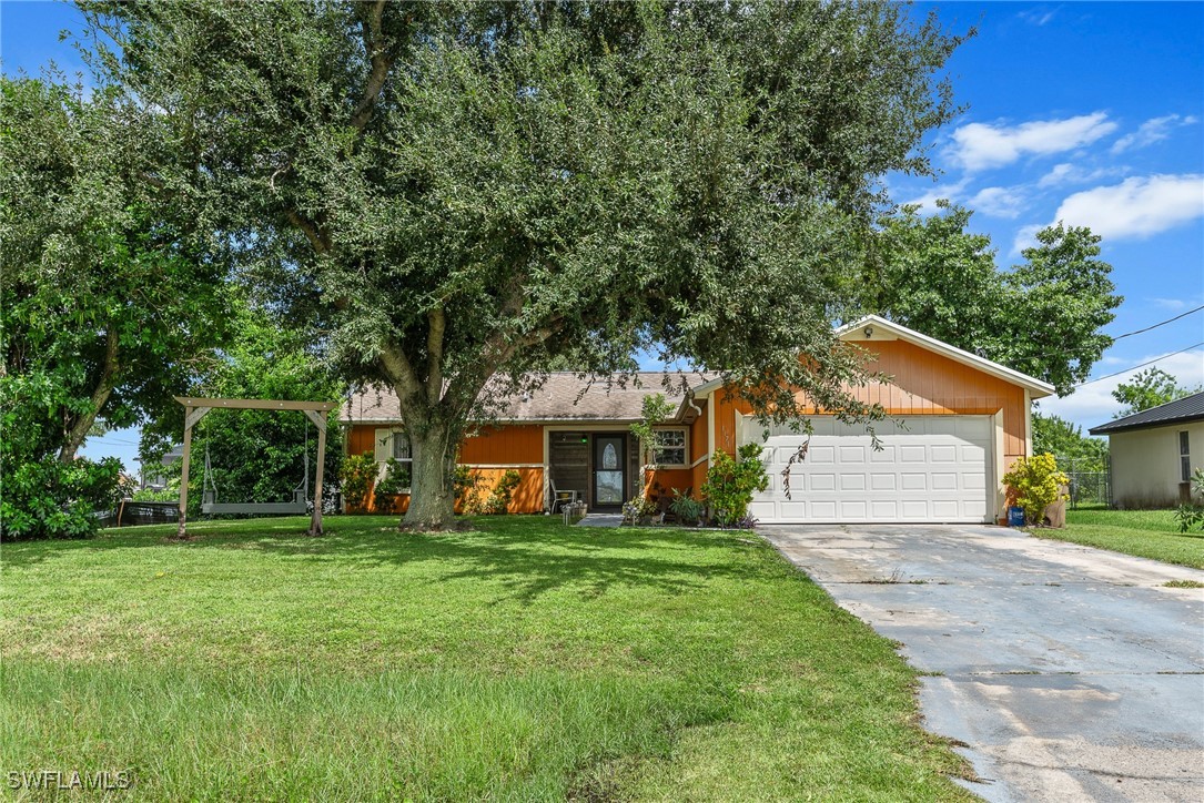 a front view of house with yard and green space