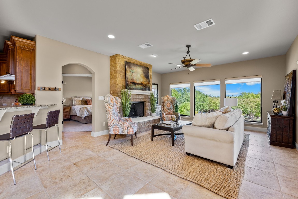 a living room with fireplace furniture and a large window