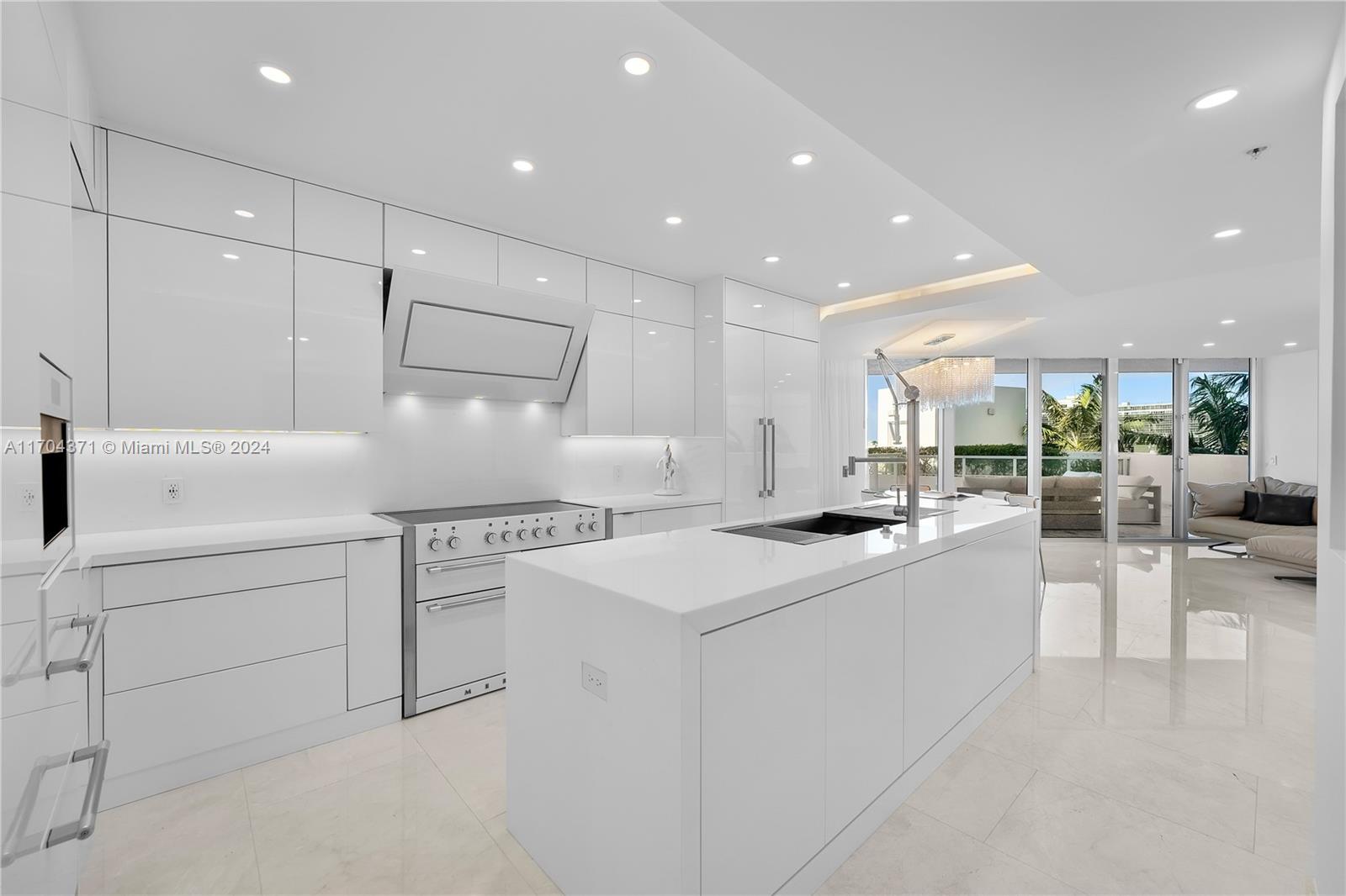 a kitchen with white cabinets and sink