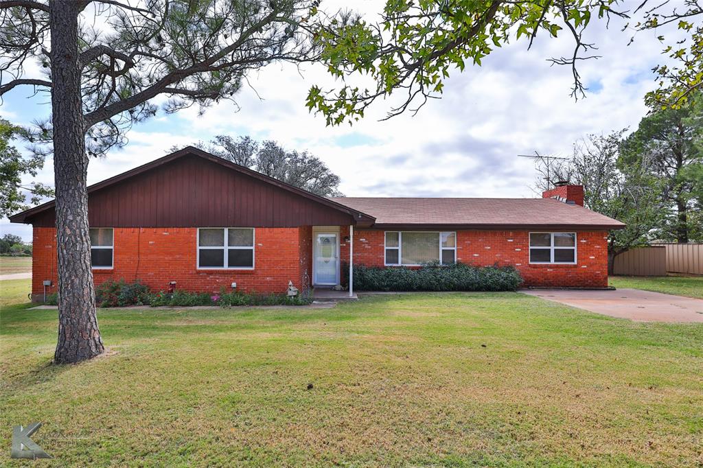 a house that has a big yard with large trees