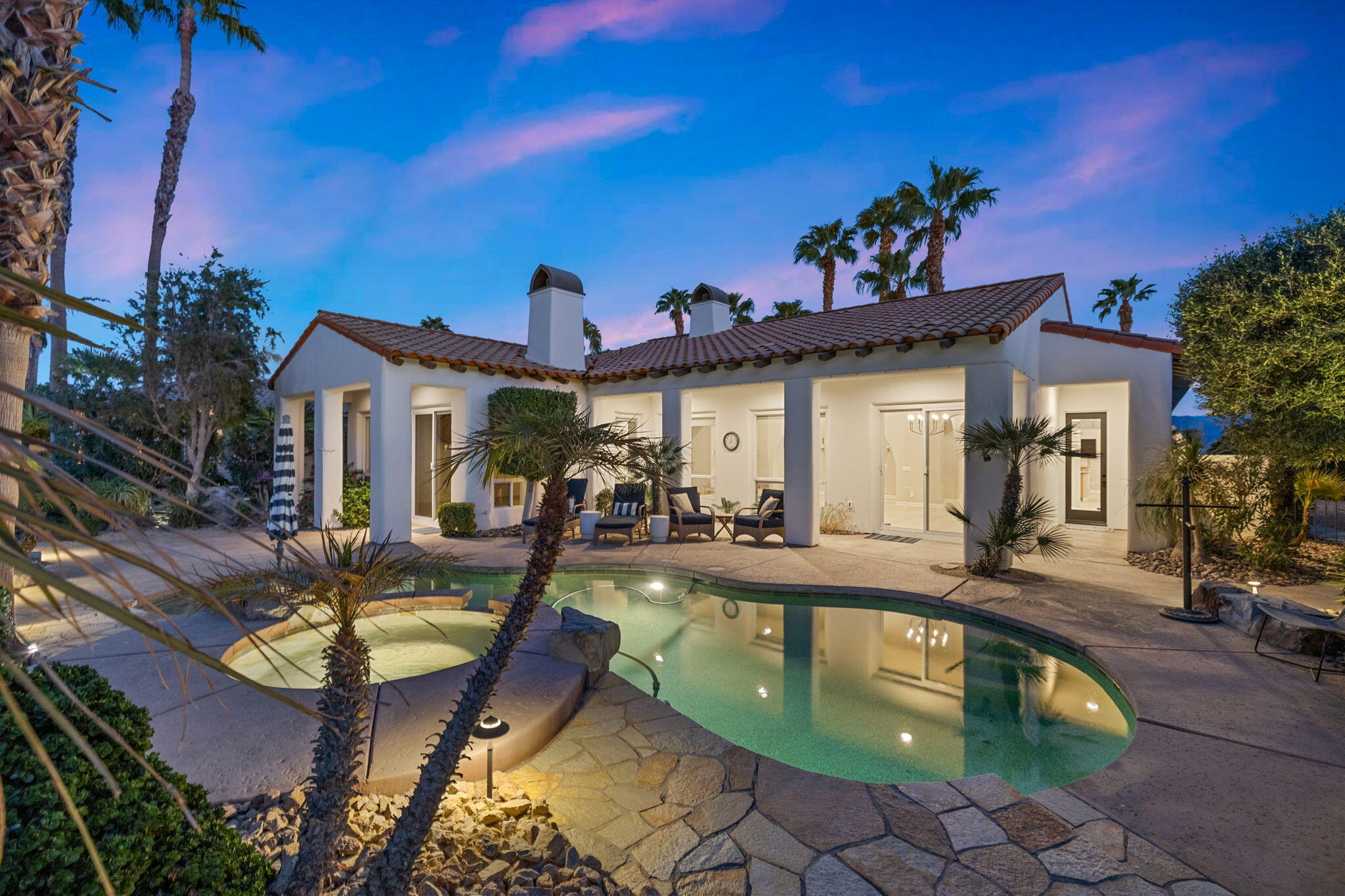 a view of a house with swimming pool and furniture