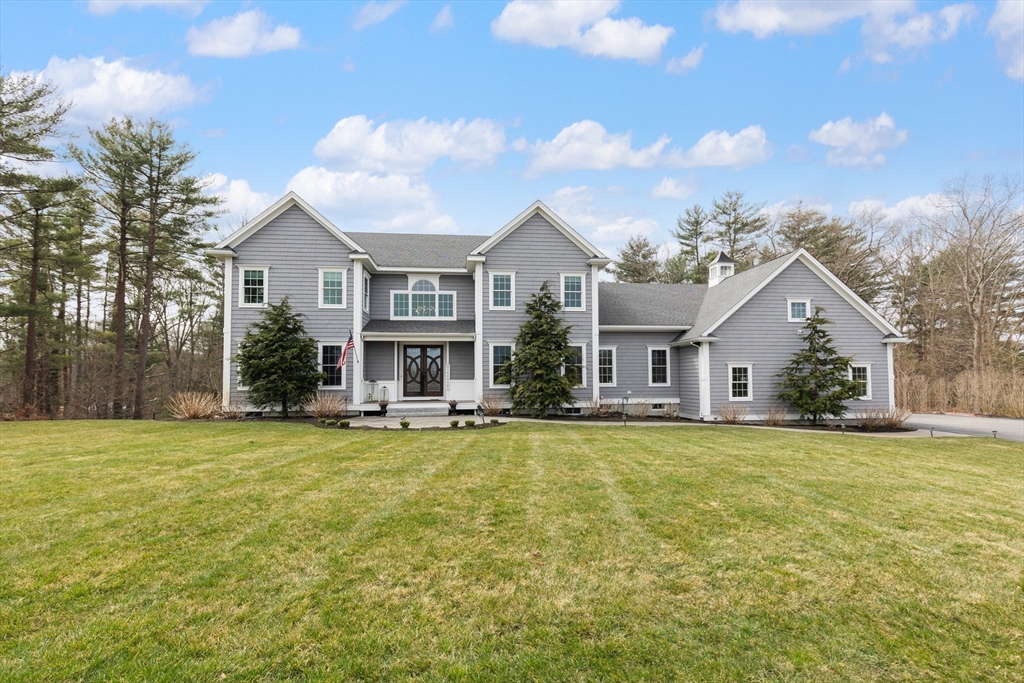 a view of a house with swimming pool and a yard