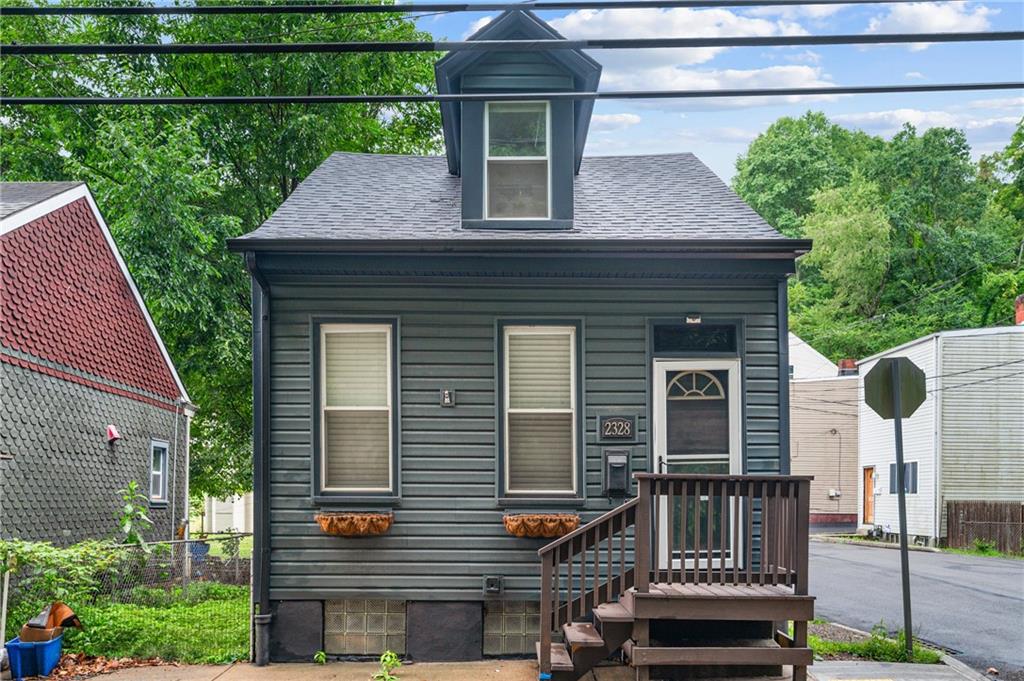 a front view of a house with plants