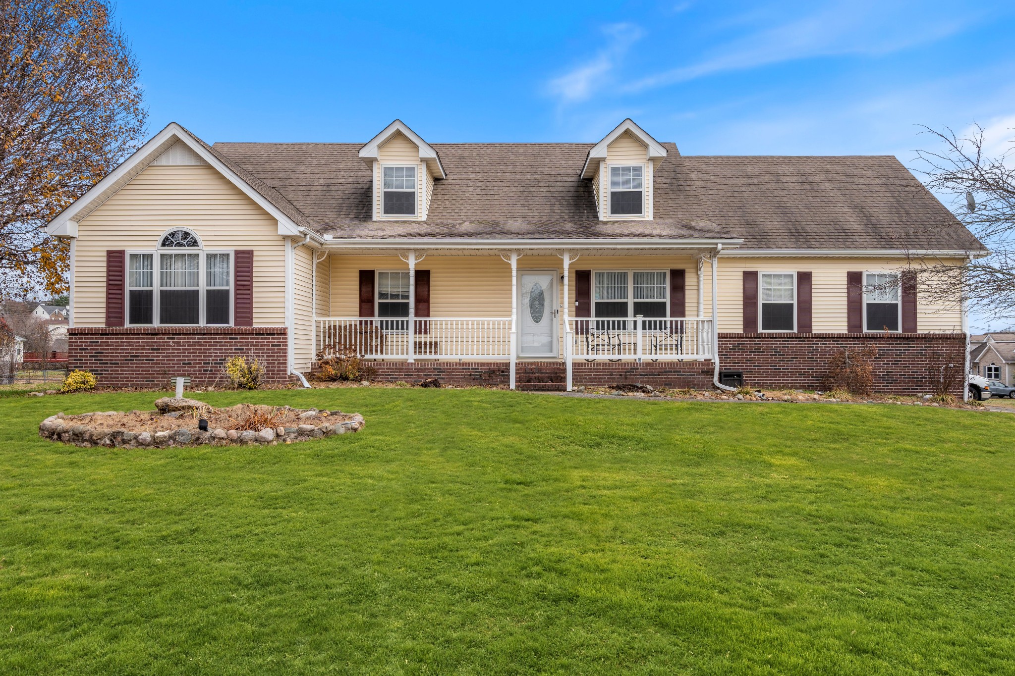 a front view of a house with a garden