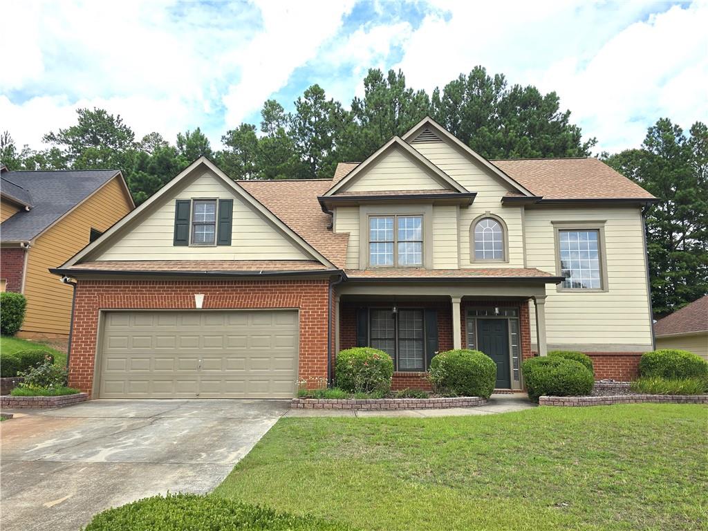 a front view of a house with a yard and garage