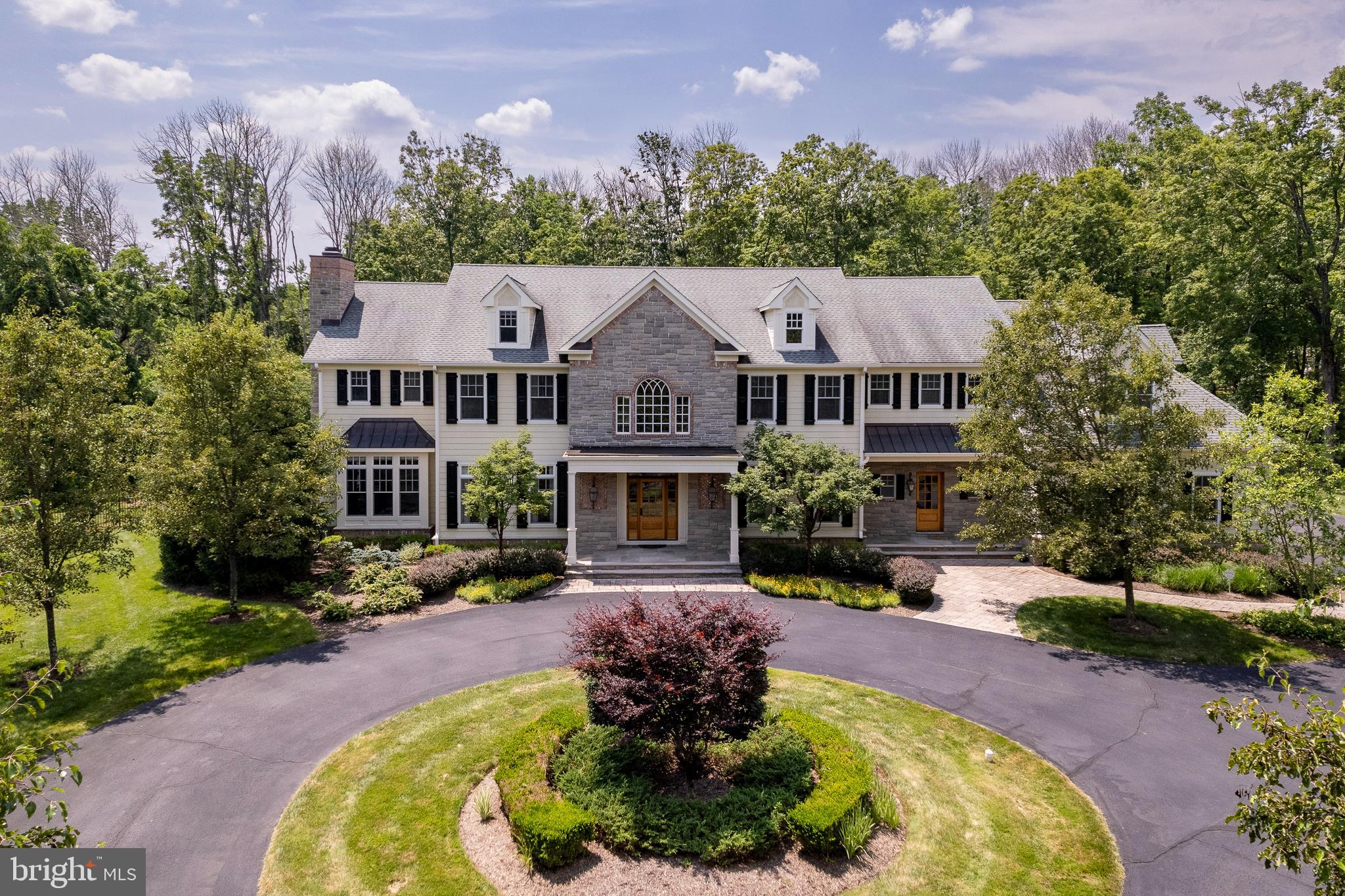 a front view of a house with a yard and outdoor seating