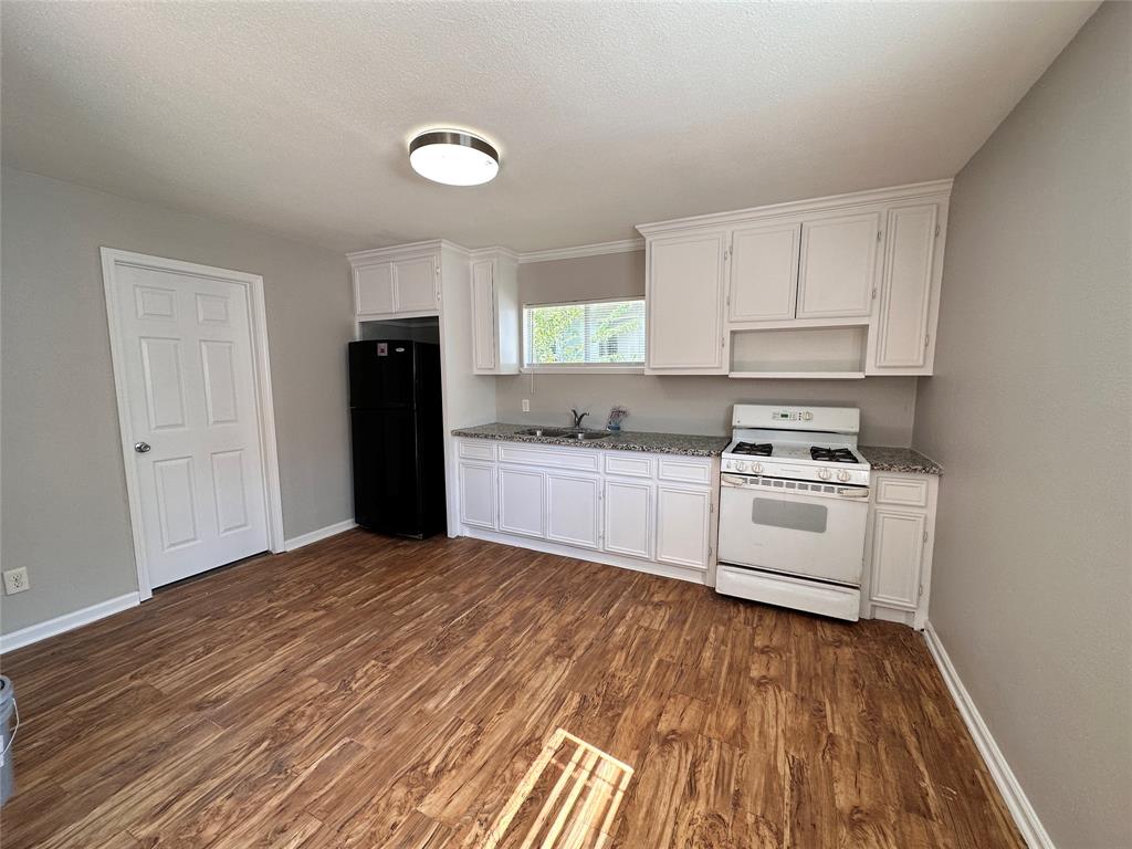 a kitchen with white cabinets and white appliances