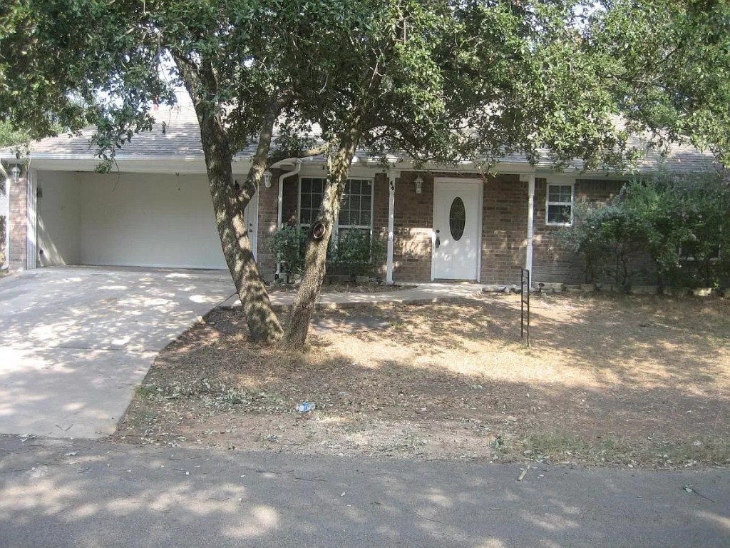 a front view of a house with yard and seating area