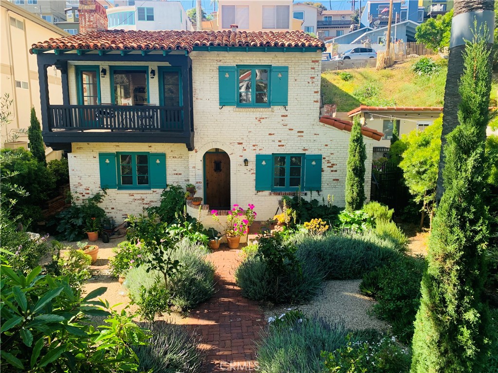 a front view of a house with a garden