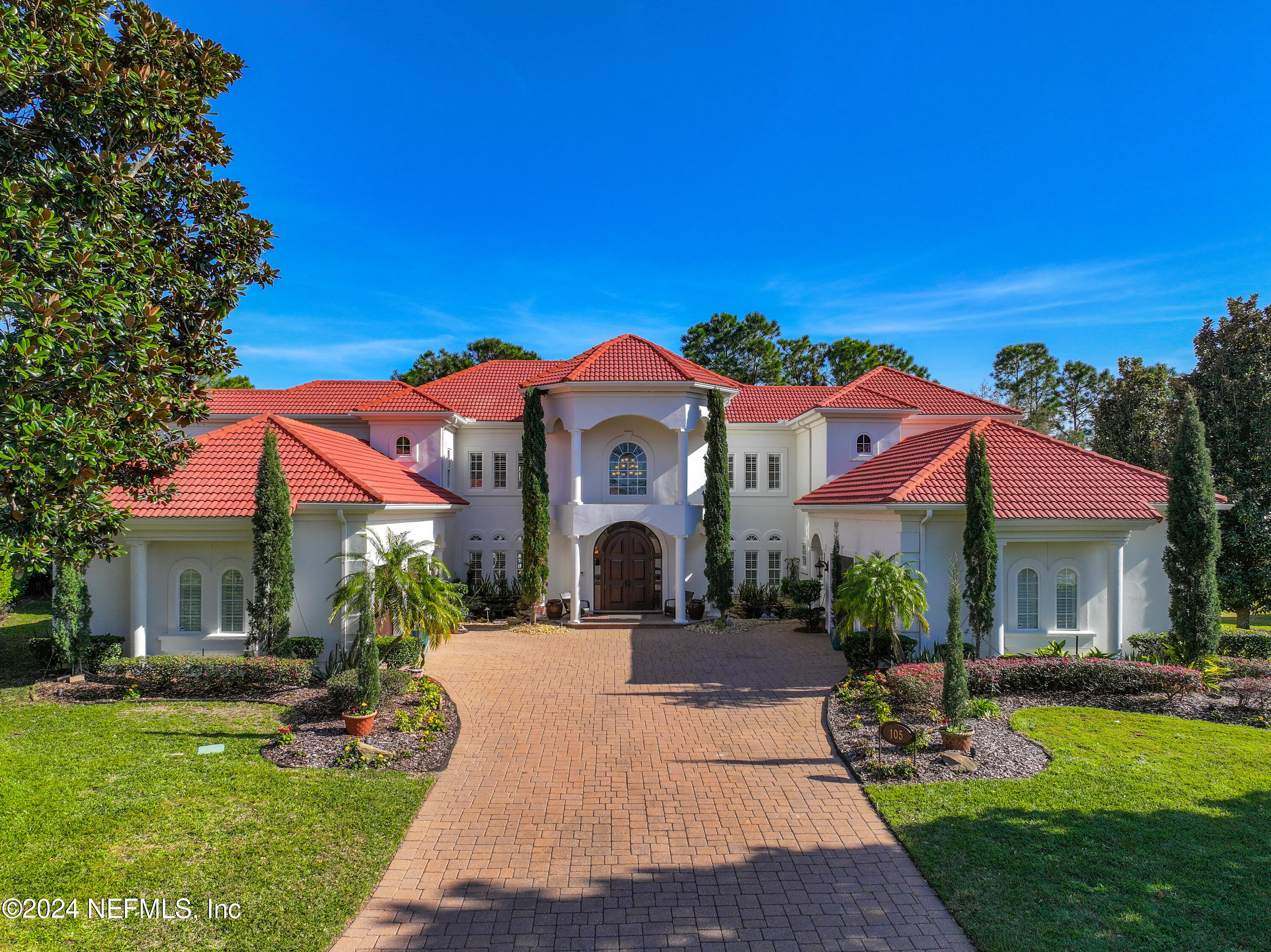 a front view of a house with garden and porch